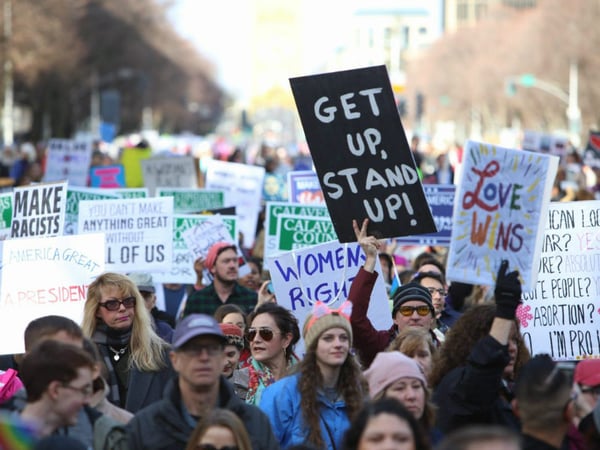 Protesters hold signs for the Women's March in Sacramento on January 21, 2017, the day after Donald Trump's inauguration.